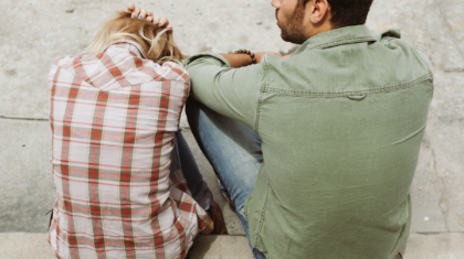 man-and-woman-sitting-on-sidewalk-226166